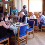 A group of people enjoying a coffee in the Kinloss hall